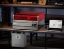 Creality Falcon2 Pro на полке рядом с ноутбуком; очиститель воздуха на фото продается отдельно